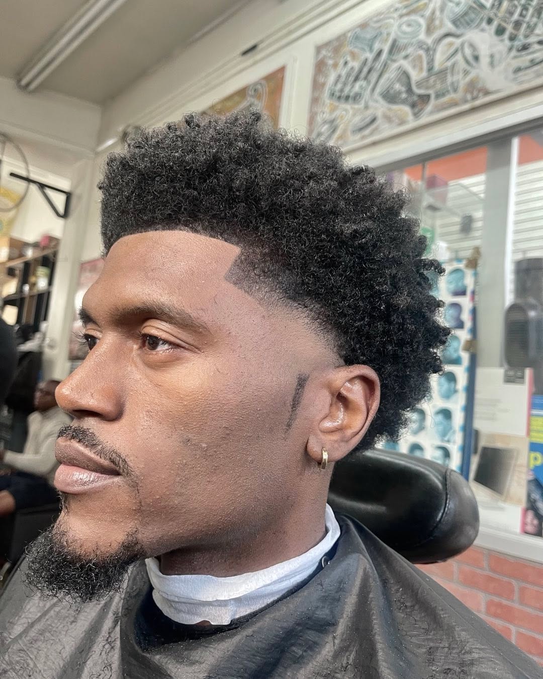Taper haircut with curls at Ro Barbershop Harlem